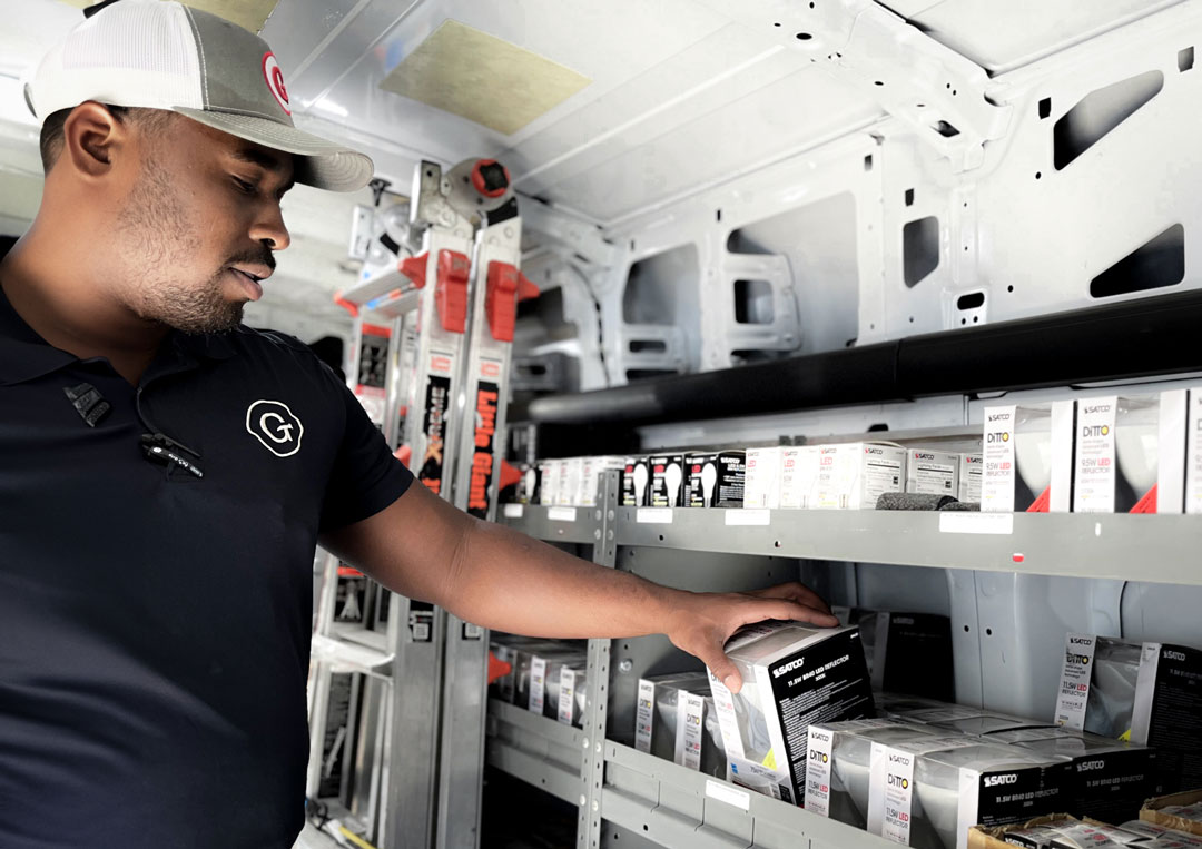 Person stocking electrical supplies in a service van.